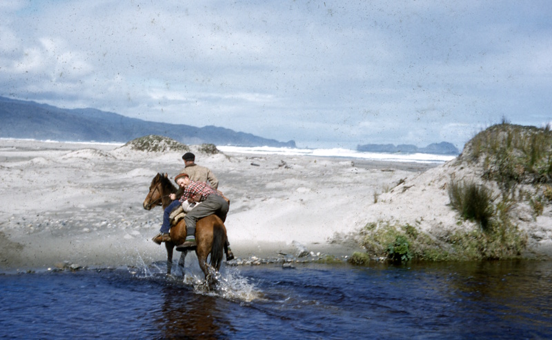 George Knox fording a river on horseback, 1958