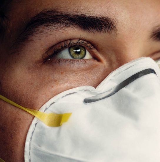 Close up of person's face wearing a face mask